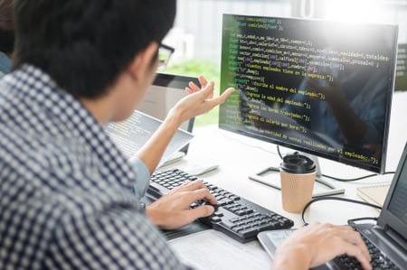 img-man-in-front-of-monitors-writing-computer-code-06