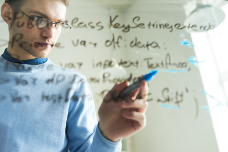 img-man-writing-computer-code-on-glass-01-variation-01